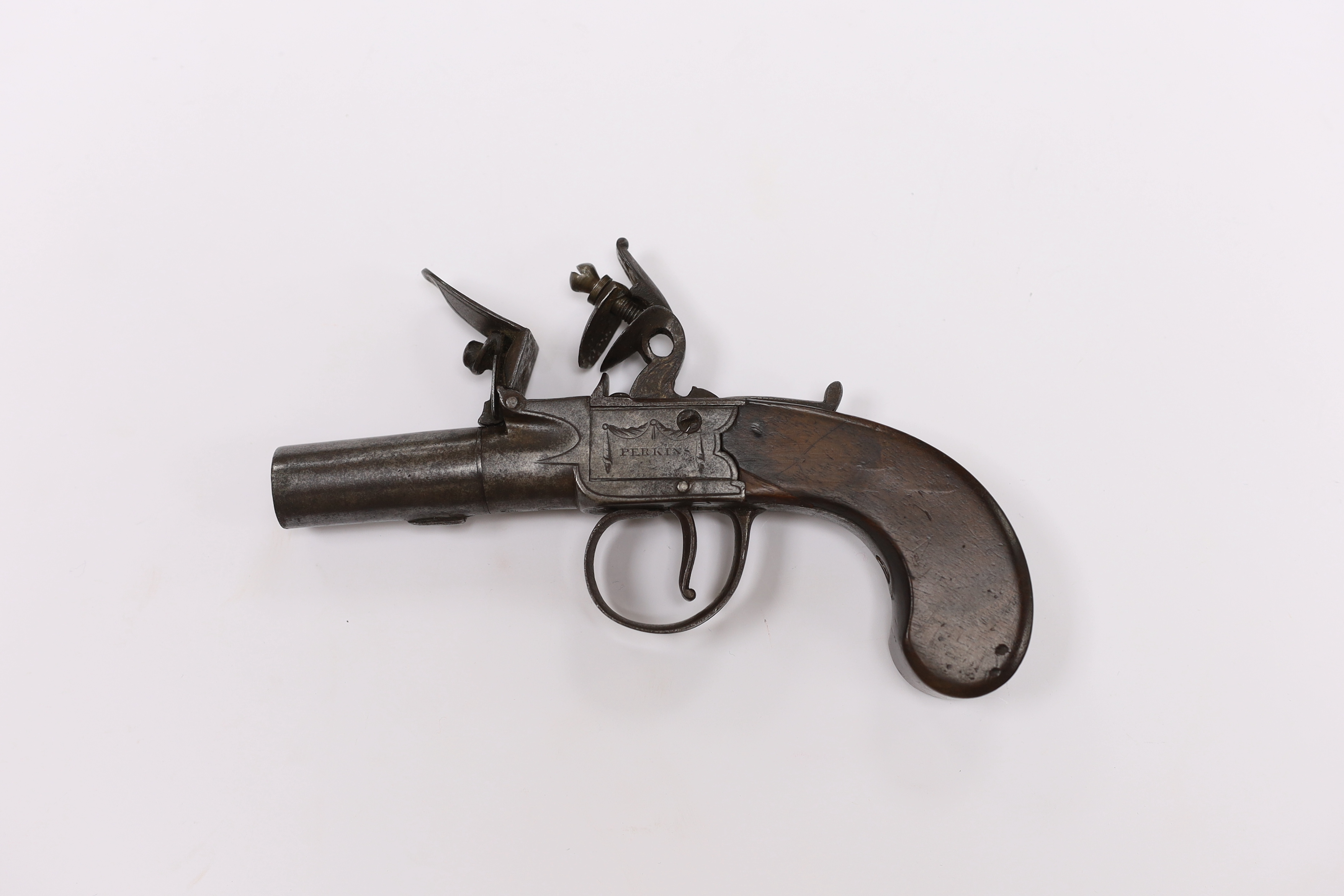 A small boxlock flintlock pistol by Perkins of London, with turn-off barrel, frame signed by the maker, with walnut slab grip, barrel 4.5cm